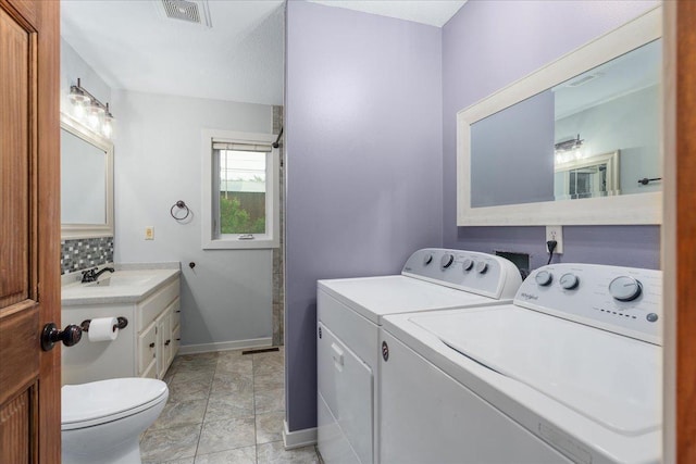 106 1/2 N St, Hudson, WI 54016 - full bath with washer and clothes dryer, toilet, baseboards, vanity, and backsplash