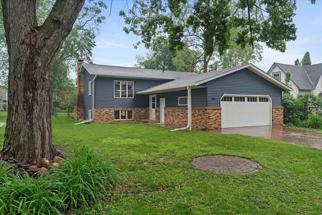106 1/2 N St, Hudson, WI 54016 - tri-level home featuring a chimney, an attached garage, driveway, a front yard, and brick siding
