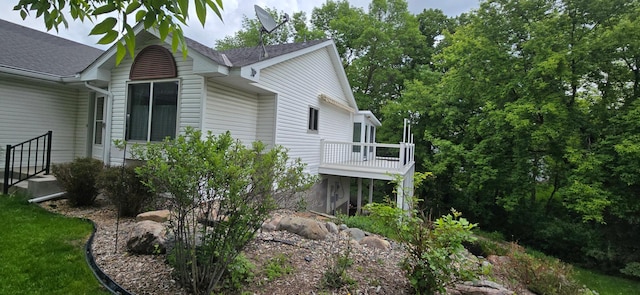 302 8th Ave S, Buffalo, MN 55313 - view of side of property featuring a shingled roof and a wooden deck