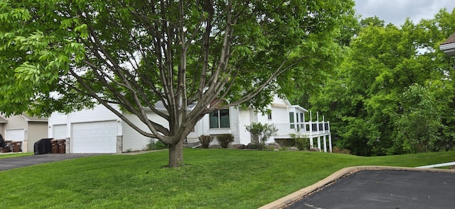 302 8th Ave S, Buffalo, MN 55313 - view of property hidden behind natural elements featuring driveway, a front lawn, and a garage
