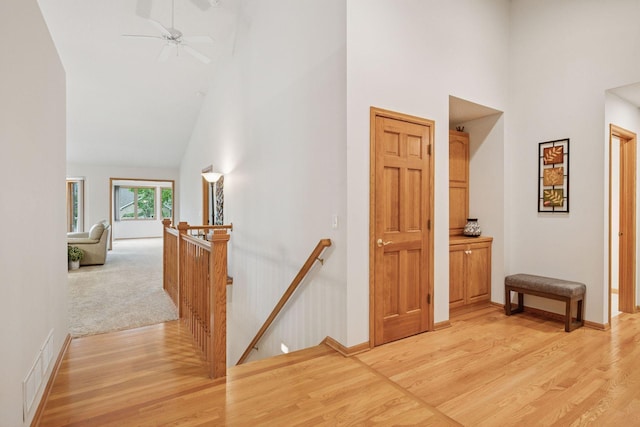 11202 Virginia Rd, Bloomington, MN 55438 - corridor with an upstairs landing, high vaulted ceiling, and light wood finished floors