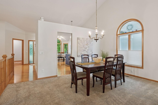 11202 Virginia Rd, Bloomington, MN 55438 - dining area with light colored carpet, lofted ceiling, and a chandelier