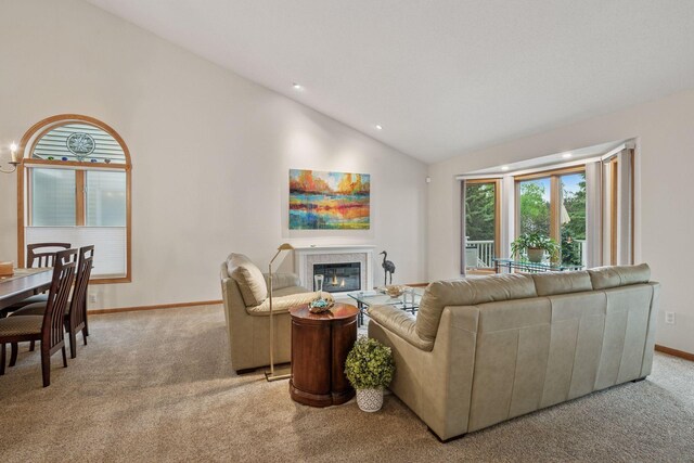 11202 Virginia Rd, Bloomington, MN 55438 - living room featuring light colored carpet, lofted ceiling, a glass covered fireplace, and recessed lighting