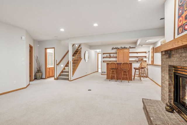 11202 Virginia Rd, Bloomington, MN 55438 - living area with bar area, stairway, light carpet, a brick fireplace, and recessed lighting