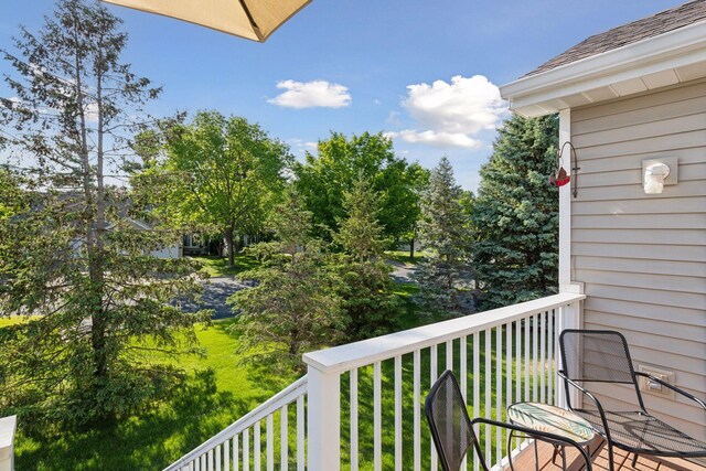 11202 Virginia Rd, Bloomington, MN 55438 - balcony featuring view of wooded area