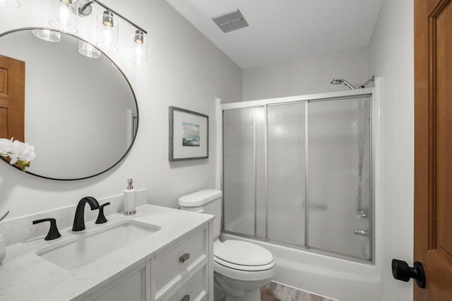 212 Eagle Lake Dr, Maple Grove, MN 55369 - bathroom with vanity, toilet, a textured ceiling, and shower / bath combination with glass door