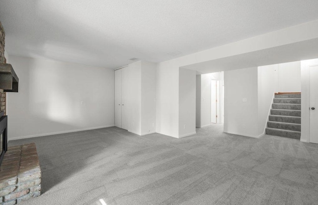 212 Eagle Lake Dr, Maple Grove, MN 55369 - unfurnished living room featuring a fireplace, stairs, carpet floors, baseboards, and a textured ceiling