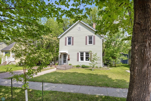 1413 11th Ave S, Fargo, ND 58103 - traditional-style house featuring a chimney and a front lawn