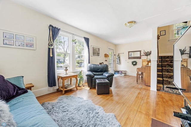 1413 11th Ave S, Fargo, ND 58103 - living area featuring stairway, light wood-style floors, and baseboards