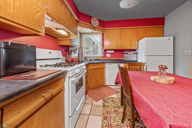 1413 11th Ave S, Fargo, ND 58103 - kitchen with white appliances, a sink, dark countertops, brown cabinetry, and light tile patterned floors