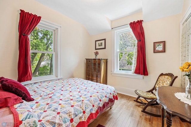 1413 11th Ave S, Fargo, ND 58103 - bedroom with multiple windows, vaulted ceiling, wood-type flooring, and baseboards