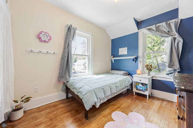 1413 11th Ave S, Fargo, ND 58103 - bedroom with wood-type flooring, lofted ceiling, multiple windows, and baseboards