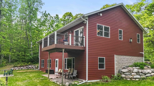 31172 Apache Cir, Breezy Point, MN 56472 - back of property featuring a balcony, a patio, a lawn, and central AC unit