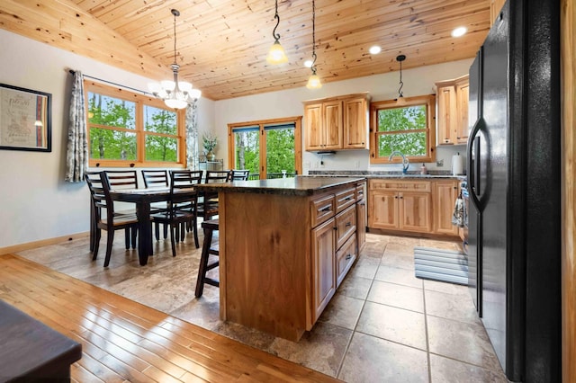 31172 Apache Cir, Breezy Point, MN 56472 - kitchen with black fridge with ice dispenser, wooden ceiling, healthy amount of natural light, a chandelier, and a kitchen island