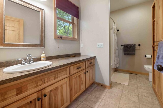 31172 Apache Cir, Breezy Point, MN 56472 - bathroom featuring vanity, toilet, baseboards, and a shower with shower curtain