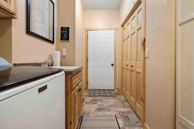 31172 Apache Cir, Breezy Point, MN 56472 - laundry room featuring washer / dryer, cabinet space, and stone finish flooring