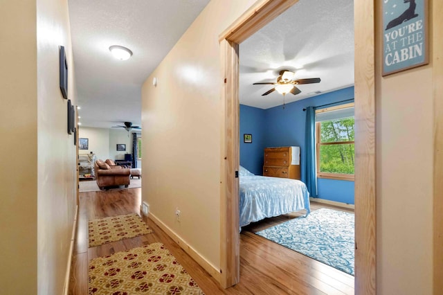 31172 Apache Cir, Breezy Point, MN 56472 - hallway with wood finished floors, baseboards, and a textured ceiling