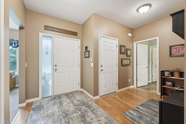 3157 Doneene Ln, Eagan, MN 55121 - entrance foyer with light wood finished floors, a textured ceiling, and baseboards