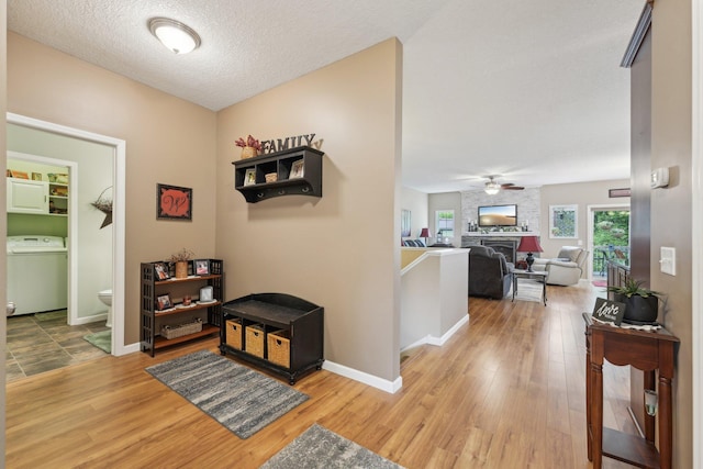 3157 Doneene Ln, Eagan, MN 55121 - hallway with washer / clothes dryer, light wood-style floors, and baseboards