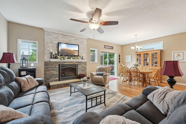 3157 Doneene Ln, Eagan, MN 55121 - living area featuring wood finished floors, a chandelier, ceiling fan, a fireplace, and a textured ceiling