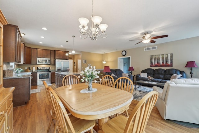3157 Doneene Ln, Eagan, MN 55121 - dining space featuring light wood-type flooring, ceiling fan, recessed lighting, and a chandelier
