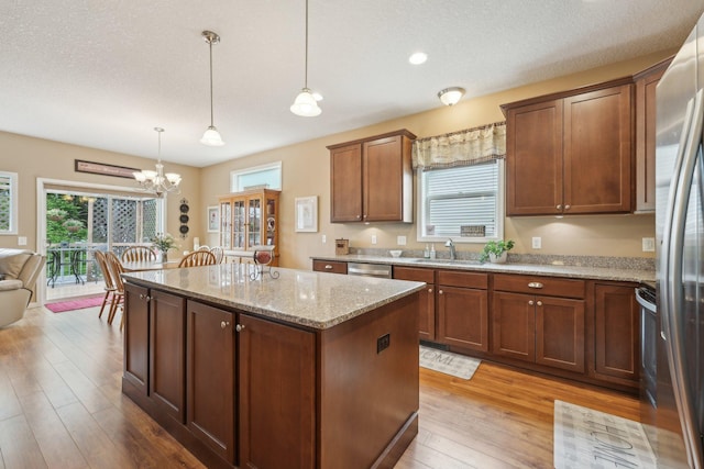 3157 Doneene Ln, Eagan, MN 55121 - kitchen featuring a sink, a kitchen island, a chandelier, appliances with stainless steel finishes, and healthy amount of natural light