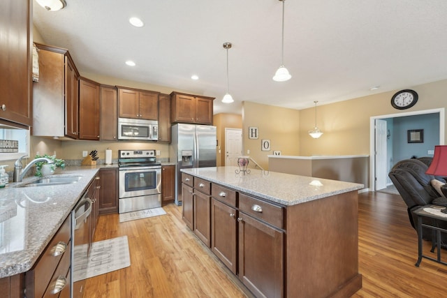 3157 Doneene Ln, Eagan, MN 55121 - kitchen featuring appliances with stainless steel finishes, light wood-type flooring, a center island, a sink, and hanging light fixtures