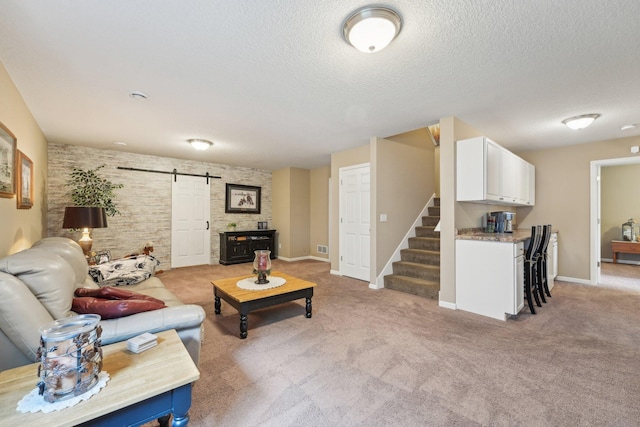 3157 Doneene Ln, Eagan, MN 55121 - living area featuring a barn door, stairs, a textured ceiling, light carpet, and baseboards