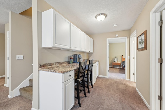 3157 Doneene Ln, Eagan, MN 55121 - office area featuring light carpet, built in study area, a textured ceiling, and baseboards