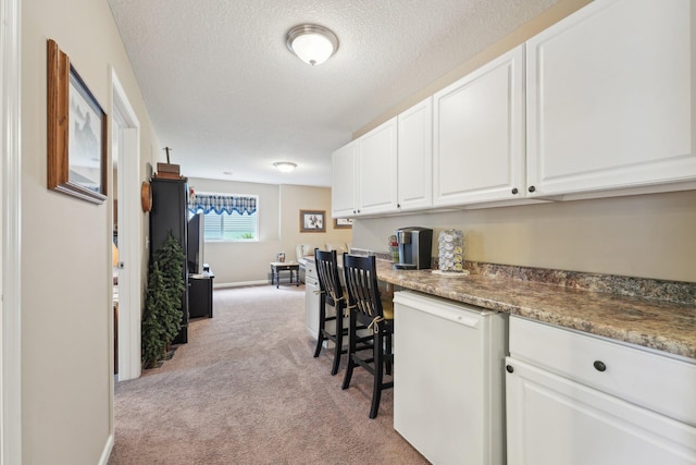 3157 Doneene Ln, Eagan, MN 55121 - office with light colored carpet, built in desk, a textured ceiling, and baseboards
