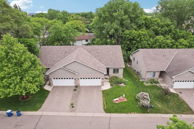 3157 Doneene Ln, Eagan, MN 55121 - view of front of home featuring stone siding, driveway, a garage, a front yard, and a shingled roof