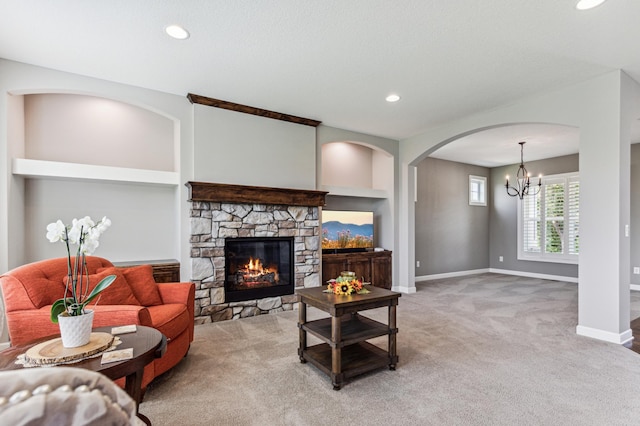 6005 Comstock Ln N, Plymouth, MN 55446 - carpeted living area with a chandelier, a fireplace, baseboards, recessed lighting, and arched walkways