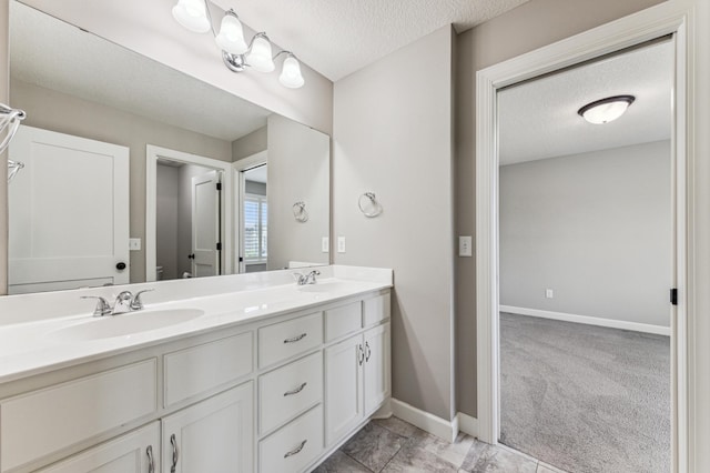 6005 Comstock Ln N, Plymouth, MN 55446 - full bath featuring a textured ceiling, double vanity, baseboards, and toilet