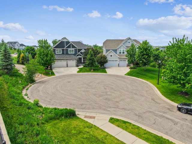6005 Comstock Ln N, Plymouth, MN 55446 - view of front of property with an attached garage, curved driveway, and a front lawn