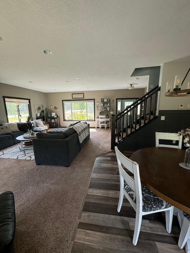 22592 43rd Ave, Saint Augusta, MN 56301 - living room featuring a textured ceiling, stairway, healthy amount of natural light, and carpet floors