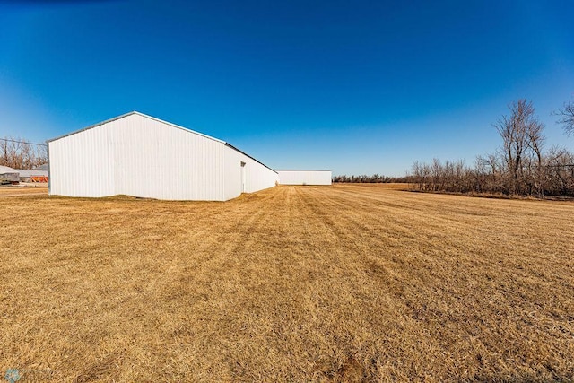 2717 88th Ave S, Fargo, ND 58104 - view of grassy yard with a pole building and an outdoor structure