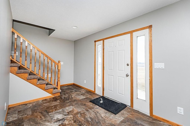 2717 88th Ave S, Fargo, ND 58104 - entrance foyer with baseboards, stone finish flooring, stairs, and recessed lighting