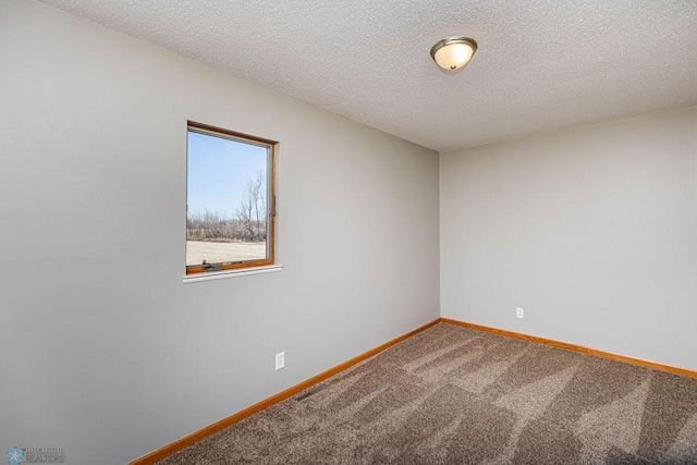 2717 88th Ave S, Fargo, ND 58104 - carpeted empty room with baseboards and a textured ceiling