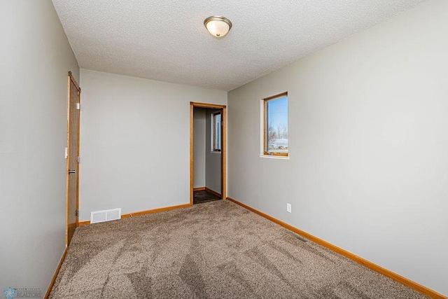 2717 88th Ave S, Fargo, ND 58104 - carpeted empty room with baseboards and a textured ceiling