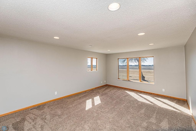 2717 88th Ave S, Fargo, ND 58104 - carpeted empty room with recessed lighting, baseboards, and a textured ceiling