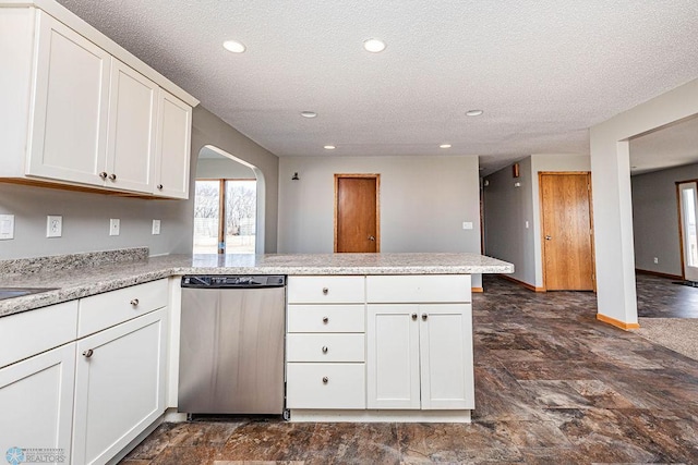 2717 88th Ave S, Fargo, ND 58104 - kitchen with stainless steel dishwasher, a peninsula, arched walkways, a textured ceiling, and recessed lighting