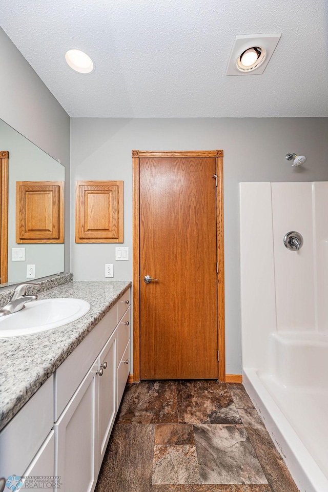 2717 88th Ave S, Fargo, ND 58104 - full bath with vanity, stone finish floors, and a shower