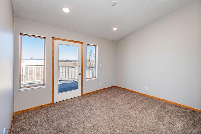 2717 88th Ave S, Fargo, ND 58104 - carpeted empty room featuring baseboards, recessed lighting, and a textured ceiling