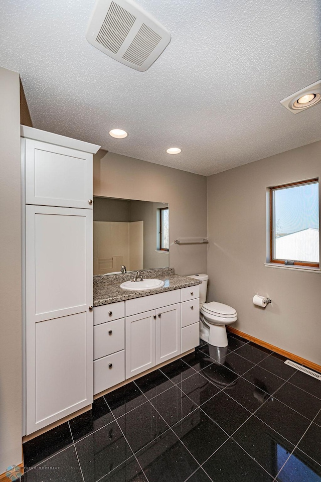 2717 88th Ave S, Fargo, ND 58104 - bathroom with recessed lighting, baseboards, vanity, granite tiled floors, and a textured ceiling