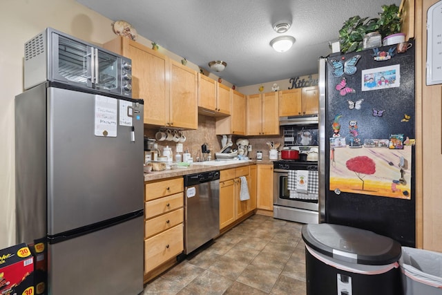 1599 Rice St, Saint Paul, MN 55117 - kitchen featuring stainless steel appliances, light brown cabinetry, under cabinet range hood, light countertops, and backsplash