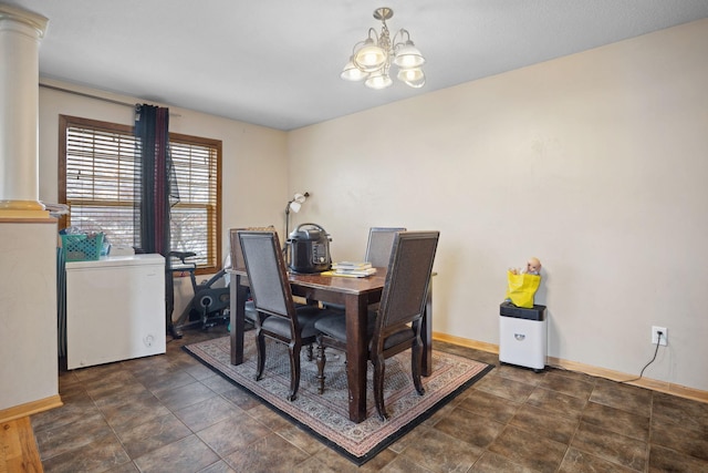 1599 Rice St, Saint Paul, MN 55117 - dining area with a chandelier, baseboards, and decorative columns