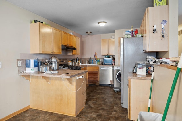 1599 Rice St, Saint Paul, MN 55117 - kitchen with stainless steel appliances, under cabinet range hood, a peninsula, washer / dryer, and light brown cabinetry