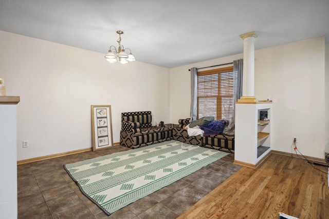 1599 Rice St, Saint Paul, MN 55117 - sitting room featuring a chandelier, decorative columns, and baseboards