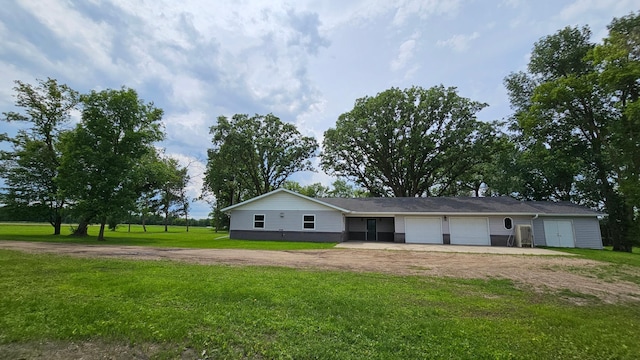 13386 Palomino Rd, Bertha Twp, MN 56437 - view of front facade with dirt driveway, a garage, and a front yard