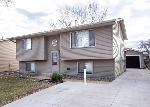 10470 Palm St NW, Coon Rapids, MN 55433 - split foyer home featuring an outbuilding, concrete driveway, and a garage